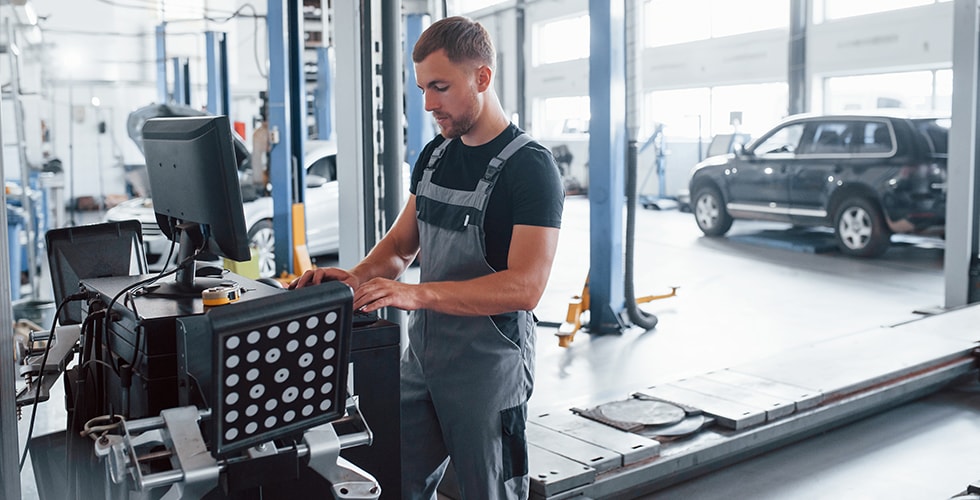 A Mechanic Using Diagnostic Tools Showcasing Practical Skills And Theory Application Pathway To Aus